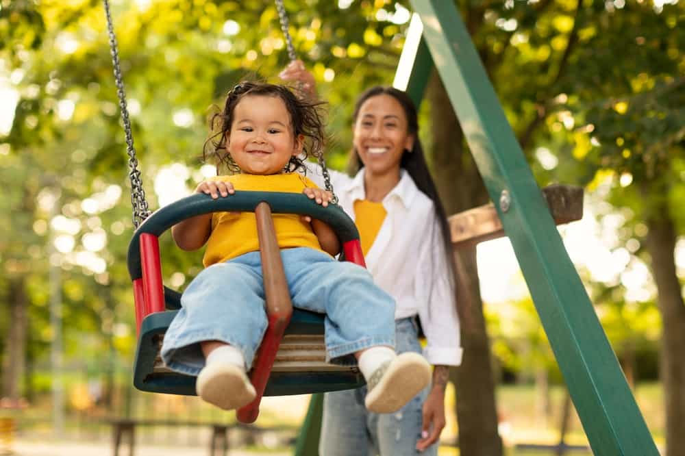child-on-swing-with-mom